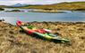 Single kayak on edge of fresh water loch