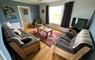 Living room with open views over the Hebridean landscape with the Haskeir Islands in the distance