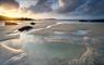 Mealasta Beach, Isle of Lewis, at sunset with golden light reflecting in rock pools and the rugged Outer Hebrides coastline, Lewis and Harris landscap
