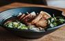 Delicious pork belly ramen with noodles and vegetables in a bowl.