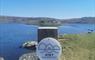 Uist Unearthed signpost in front of loch