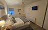 Main bedroom with TV and en-suite Heisgeir View Holiday Cottage