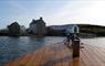 Photo of the Taigh Chearsabhagh building taken from a boat on the sea below.