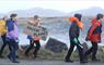 A group of schoolchildren in outdoor clothing walking along a road with a cardboard placard, with the words "There is no backup planet!"