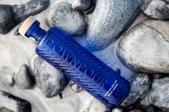 North Uist Distillery's Scottish Dry Gin, sitting on white sand, overlooking the sea