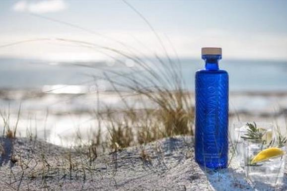 Eat Drink Hebrides - Downpour Scottish Dry Gin, on the white sand of Balranald beach, overlooking the sea