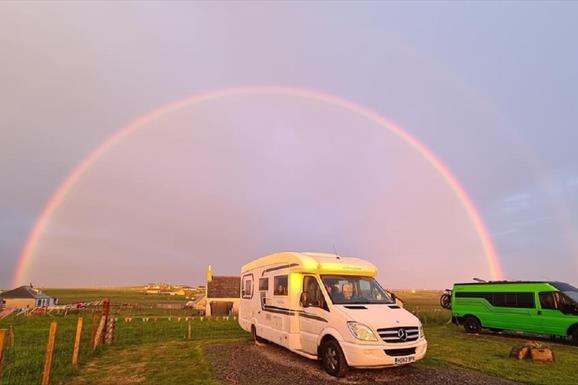 The Uncles Croft rainbow over parked vans