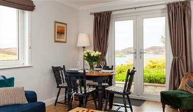 Grey Goose Cottage dining area with a view of the loch
