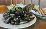 HS1 Cafe Bar in Stornoway, bowl of mussels and garlic bread on table.