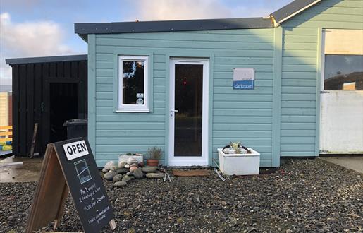 photography gallery on the isle of lewis, blue timber building with fine art photography and traditional darkroom