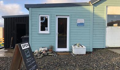 photography gallery on the isle of lewis, blue timber building with fine art photography and traditional darkroom