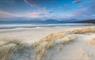 Luskentyre beach on the  Isle of Harrris, beach view with shell sand beach and link sunset sky.