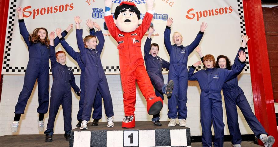 Picture of children celebrating on the winners podium Prestige Karting Pendle