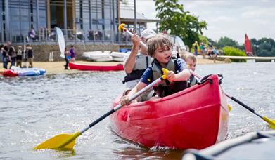 A family canoeing in Ferry Meadows