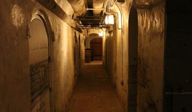 A dimly lit photo of a corridor within the Priestgate Vault.