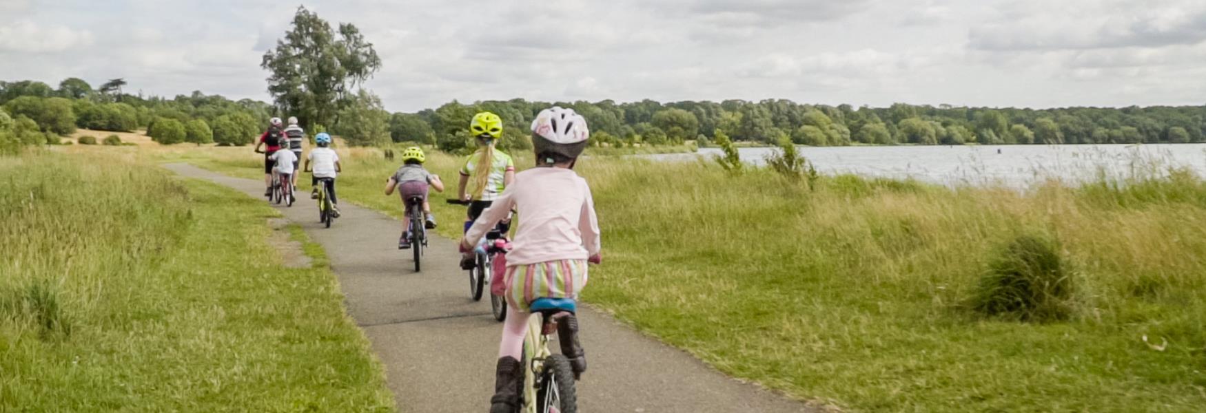 A family cycling around Nene Park.