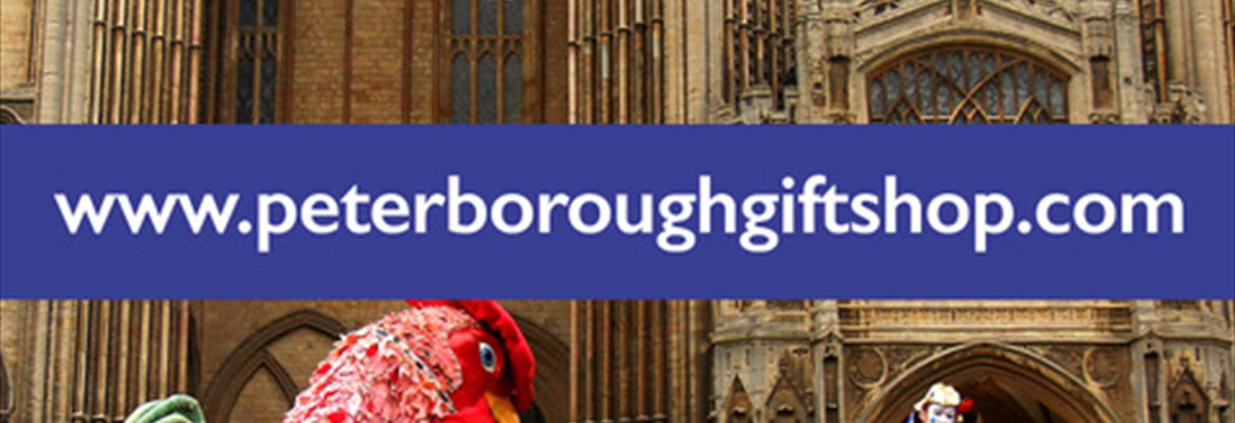 A person in a chicken costume chasing a clown in front of the Peterborough Cathedral