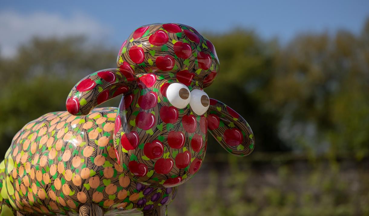 Red and orange Shaun the Sheep statue