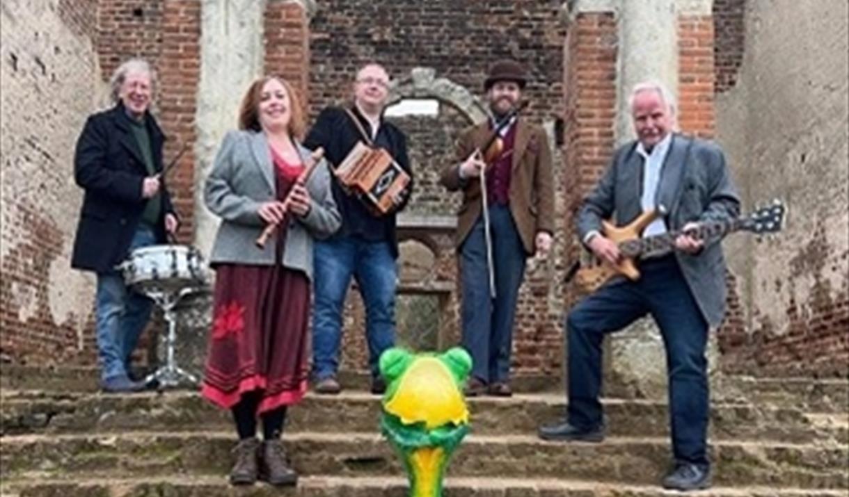 The Ceilidh band 'Frog on a Bike' stand holding their instruments on the Cathedral steps.