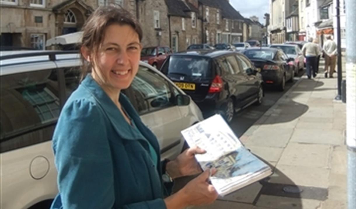Karen Neale is pictured wearing a blue coat and smiling.