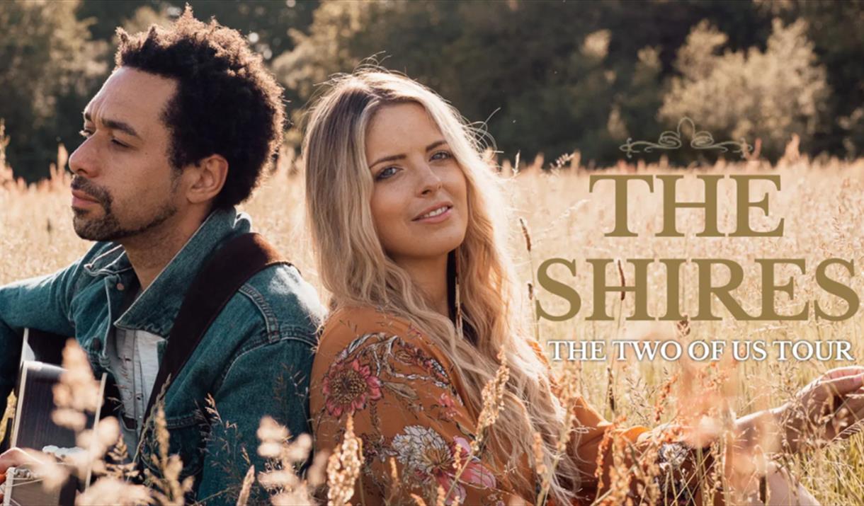 Image of the Shires sitting in a field. Text reads: The Shires, the Two of Us tour.