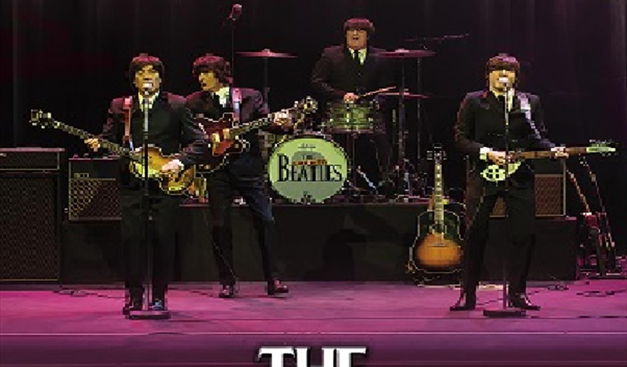 Image of a Beatles tribute band performing. Text reads: 'the Cavern Beatles'.