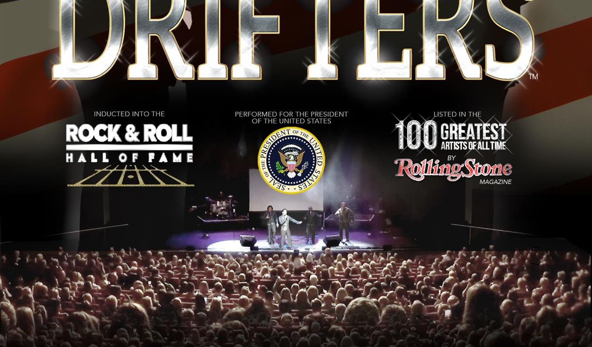 An image of a huge crowd watching the Drifters perform. On the background of the American flag, text reads: 'the Drifters'.