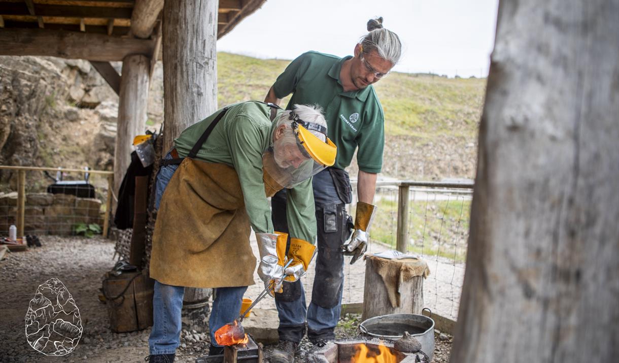 Workshop leader instructing participants when pouring molten bronze into a cast