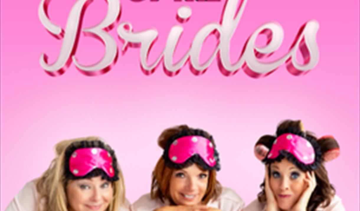 A pink background with three ladies with sleeping masks on their heads smiling on the edge of a bed. Text reads 'Mothers of the Brides'