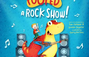 Danny and Dino performing onstage with a guitar against a blue background. Text reads 'A new musical adventure live on stage. The Dinosaur that Pooped