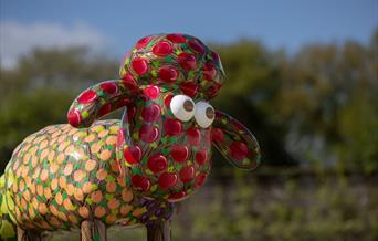 Red and orange Shaun the Sheep statue