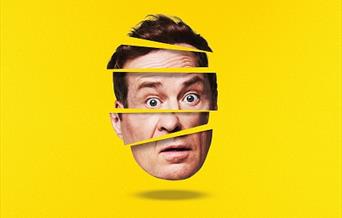 Ardal O'Hanlon's face geometrically sliced up against a yellow background