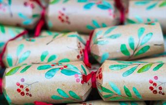 A close up image of holly printed Christmas crackers.