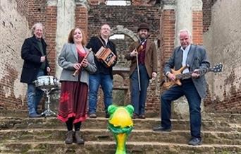 The Ceilidh band 'Frog on a Bike' stand holding their instruments on the Cathedral steps.