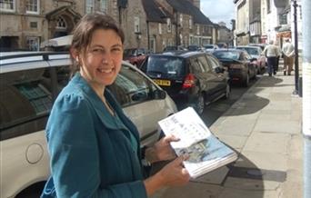 Karen Neale is pictured wearing a blue coat and smiling.