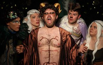 Elves and other mythical creatures look afraid of a singing satyr. Photo by Jon Lo Photography