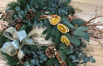 Luxury Christmas wreath with green foliage, dried fruit