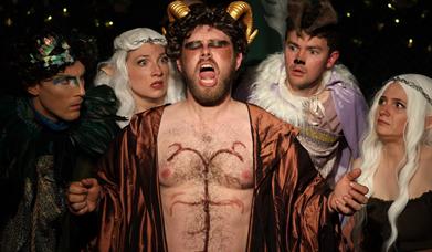 Elves and other mythical creatures look afraid of a singing satyr. Photo by Jon Lo Photography
