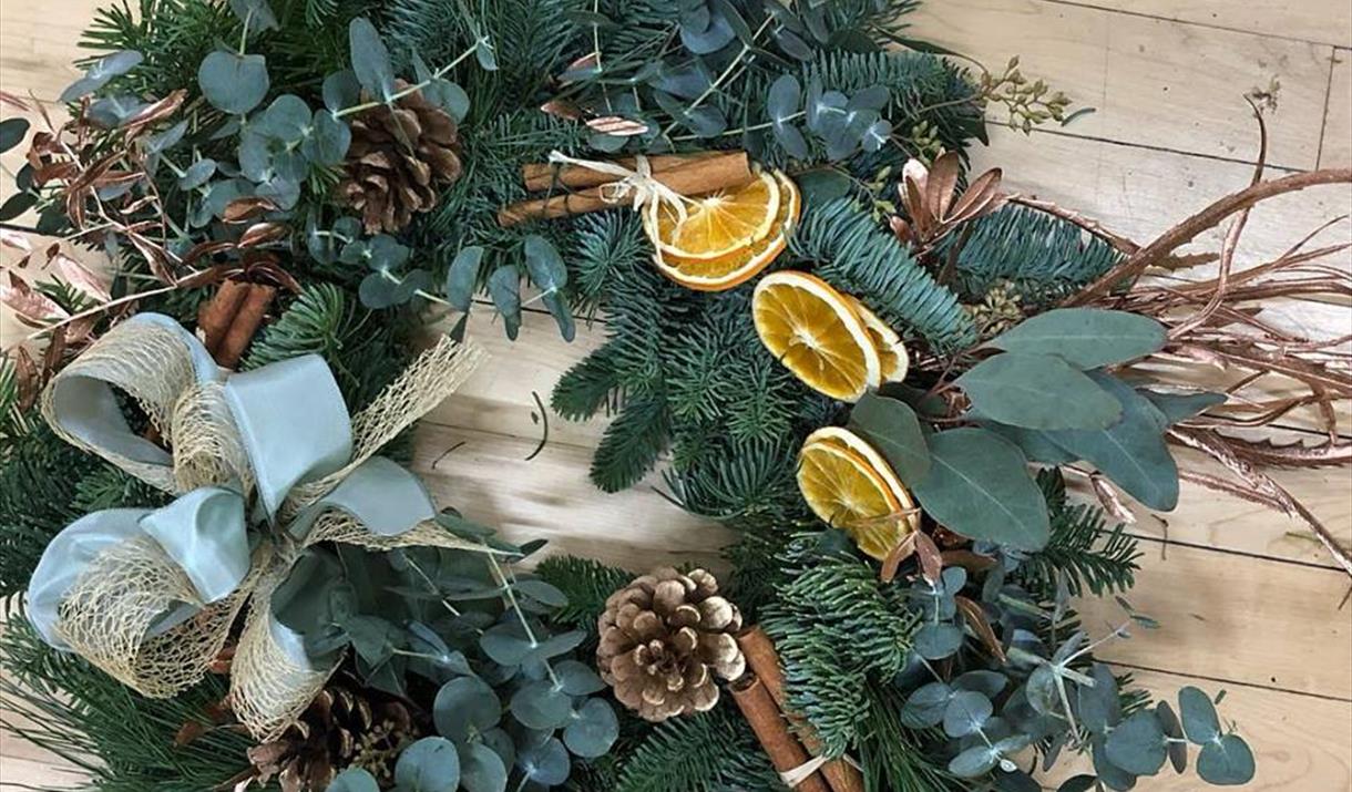 Luxury Christmas wreath with green foliage, dried fruit