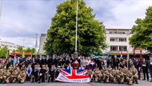 Members of the Armed Forces hold an Armed Forces Day Flag in Plymouth City Centre 