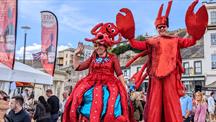 Two people in lobster outfits for Seafest  