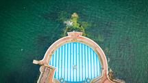 A birds' eye view of Tinside Lido swimming pool in Plymouth with water on either side.