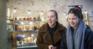 Visitors exploring an indoor Christmas market