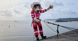 DAA Mascot, Ambrose, ready to abseil down a wall.