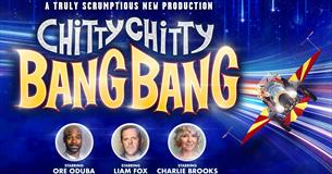 Blue backdrop with flying chitty car and cast members, Ore Oduba, Liam Fox and Charlie Brooks.