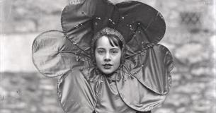 black and white photo of the girl wearing a flower collar