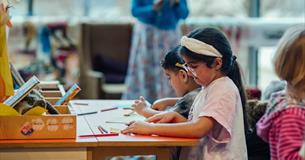 Two girls take part in a craft activity at The Box Plymouth