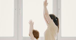 A mother and child taking part in a yoga session