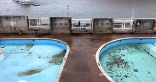 Photograph showing an outdoor pool out of season.