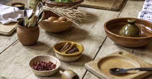 An array of ingredients in bowls set out on a wooden table